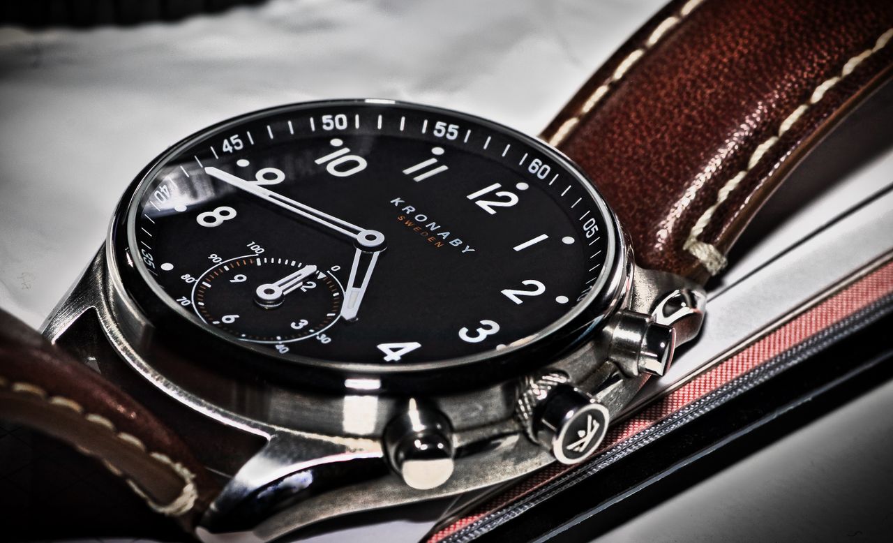 Elegant Kronaby wristwatch with leather strap and black dial captured in close-up.